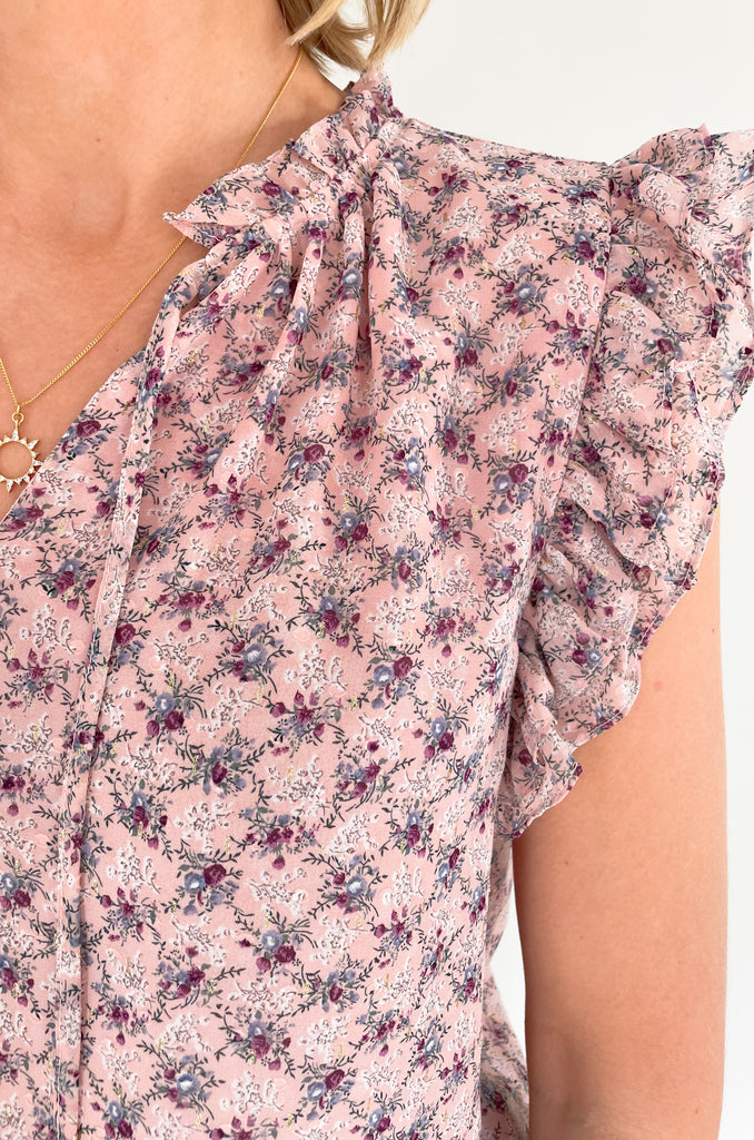 This stunning top is made of a lightweight, sheer material with a matching underlay for an elegant touch. Delicate gold thread runs throughout the shirt, while the ruffle sleeves and drawstring neckline add extra flair and structure. Perfect for any occasion, this top will make a statement.