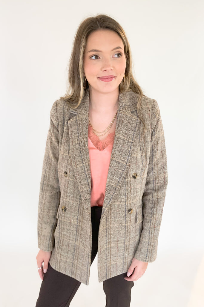 This Double Breasted Herringbone Blazer by Molly Bracken contains threads of mixed blue, mauve, and rust. The mixed colors are so unique, making it easy to match with multiple looks. We paired it with our new Dianne Lace Trim Satin Cami. Its lightweight lining adds softness and comfort, making it perfect for formal or everyday wear. 