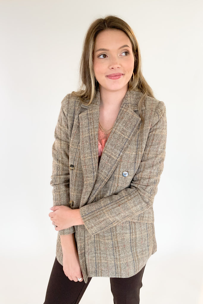 This Double Breasted Herringbone Blazer by Molly Bracken contains threads of mixed blue, mauve, and rust. The mixed colors are so unique, making it easy to match with multiple looks. We paired it with our new Dianne Lace Trim Satin Cami. Its lightweight lining adds softness and comfort, making it perfect for formal or everyday wear. 