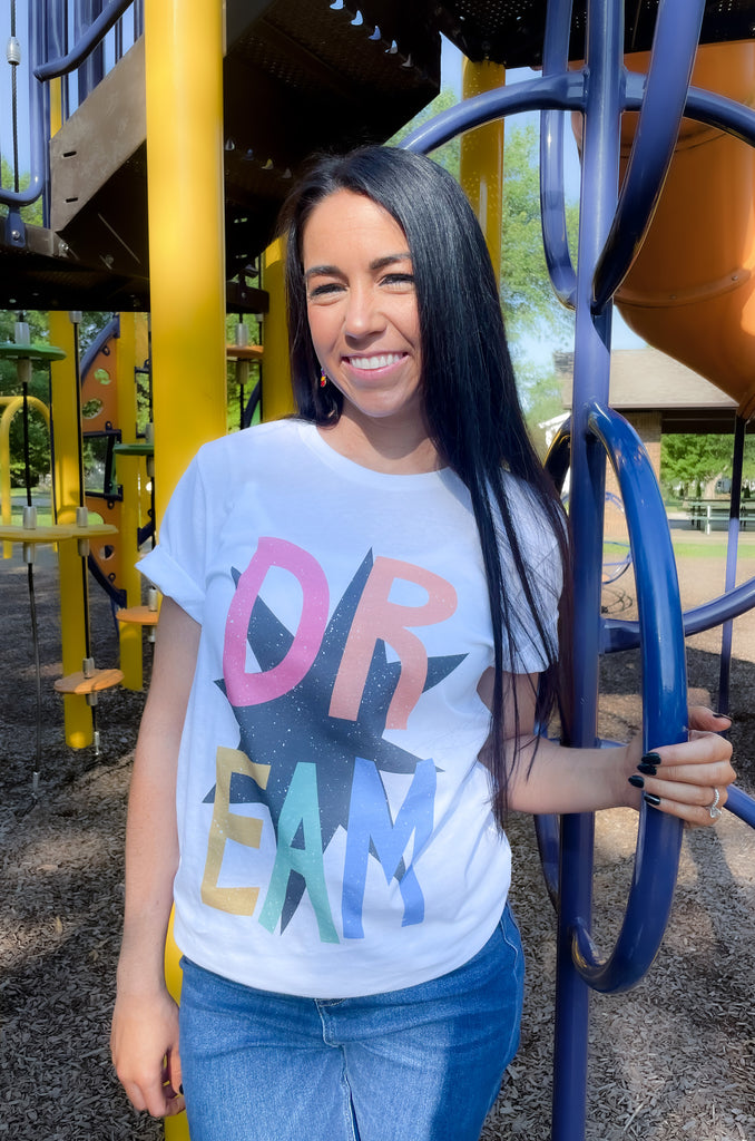 round neck short sleeve graphic tee with "DREAM" colorful text and black star print