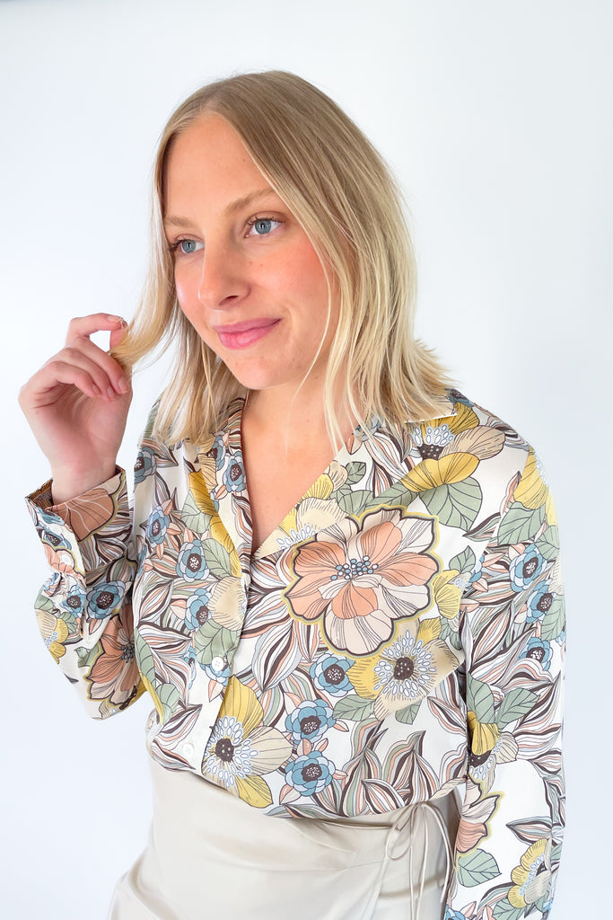 The Ecru Apricot Floral Long Sleeve Blouse is gorgeous! The floral print and fall colors make this blouse stand out. It's lightweight and elevated, perfect for dressing up a look. It pairs beautifully with our Emily Wide Leg Pants in brown. 