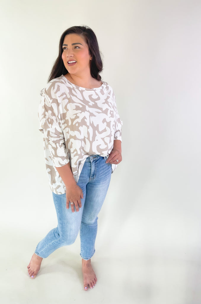 This Ecru Printed Smocked Sleeve Blouse is the perfect combination of style and comfort! Its lightweight oversized silhouette and unique pattern make it an eye-catching top while the smocked sleeves allow for an adjustable fit! Perfect for any casual or dressy outfit!