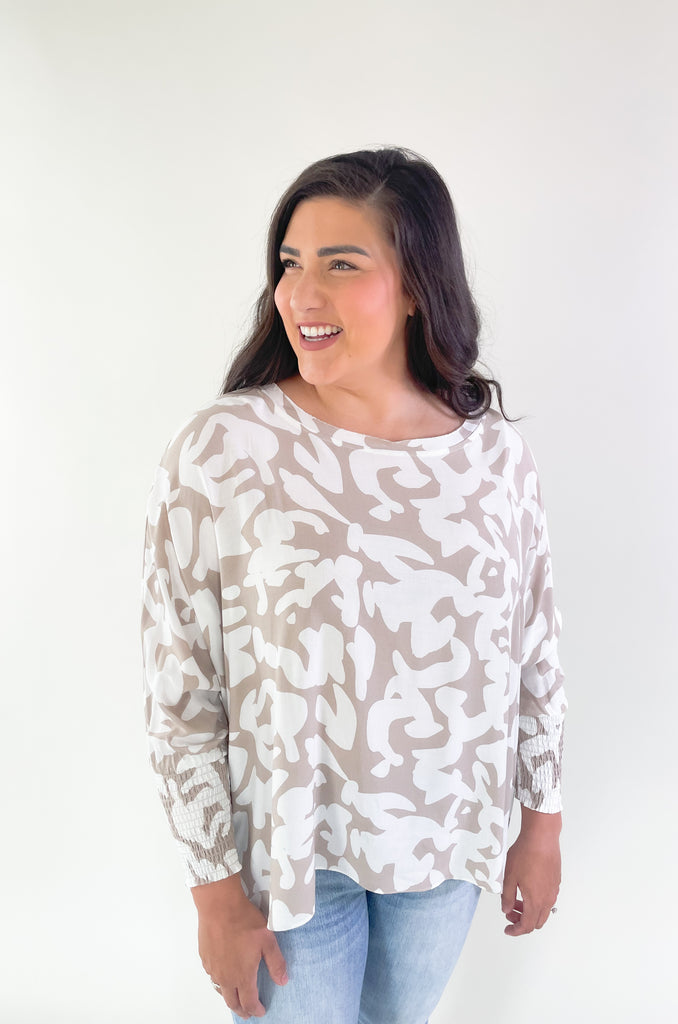 This Ecru Printed Smocked Sleeve Blouse is the perfect combination of style and comfort! Its lightweight oversized silhouette and unique pattern make it an eye-catching top while the smocked sleeves allow for an adjustable fit! Perfect for any casual or dressy outfit!