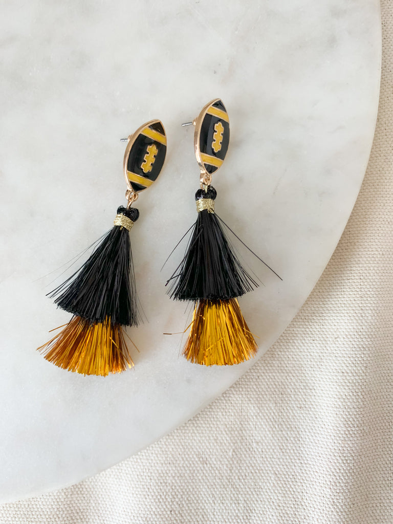 The Enamel Black and Gold Football Drop Earrings are so fun for game day! Because the tassels are woven with yarn and iridescent material, they are lightweight for all day wear. These are perfect for any Iowa fan!