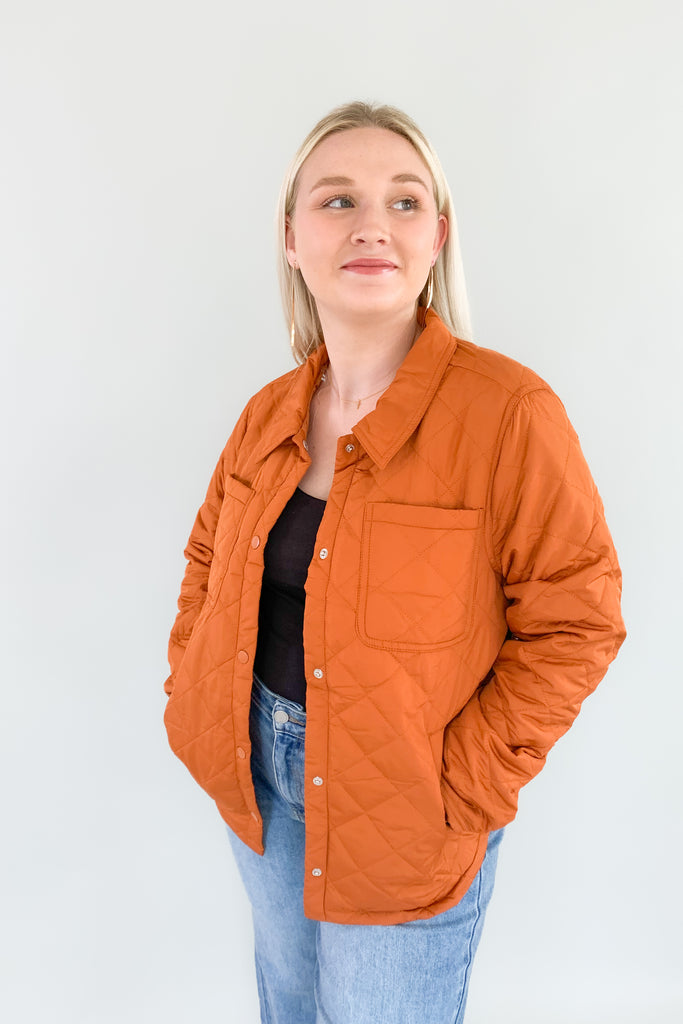 Orange quilted puffer jacket with snap buttons