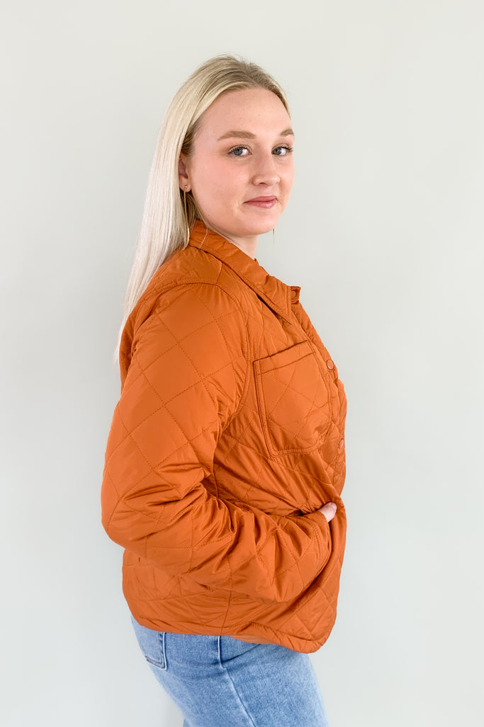 Orange quilted puffer jacket with snap buttons
