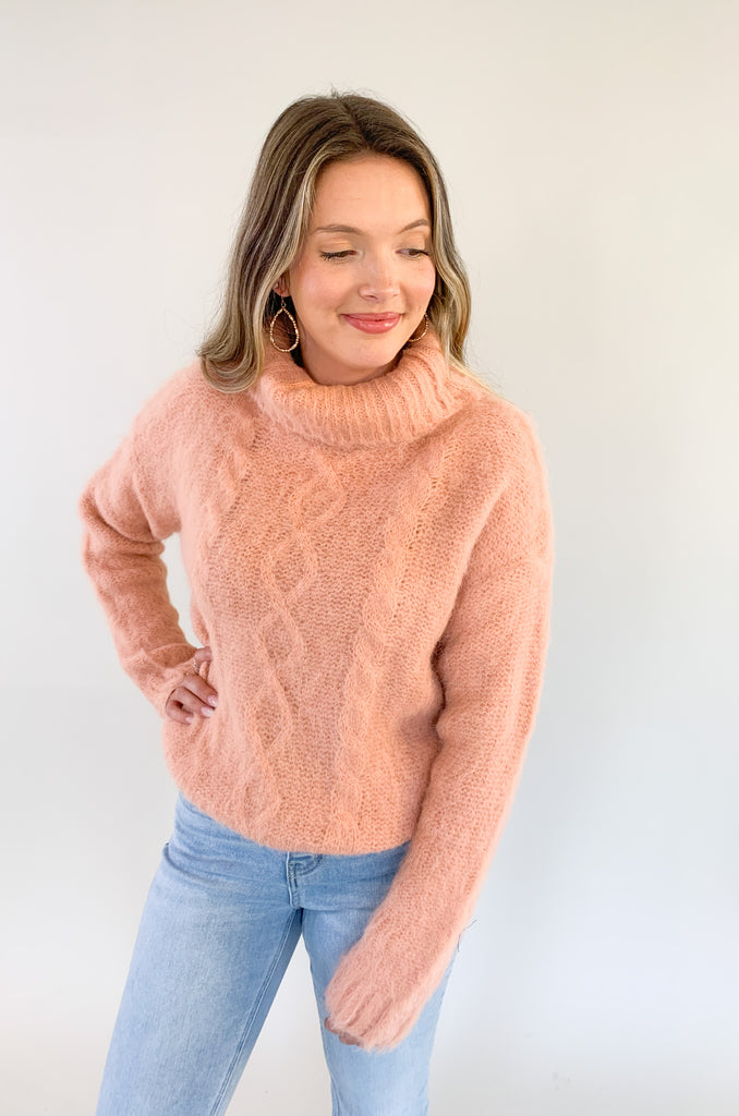 The Molly Bracken Eyelash Cable Knit Turtleneck Sweater is so pretty and luxe! The fabric is super soft with a unique eyelash cable knit fabric. The oversized chunky turtleneck look could not be more classic than this. You can dress it up or down for so many occasions. 