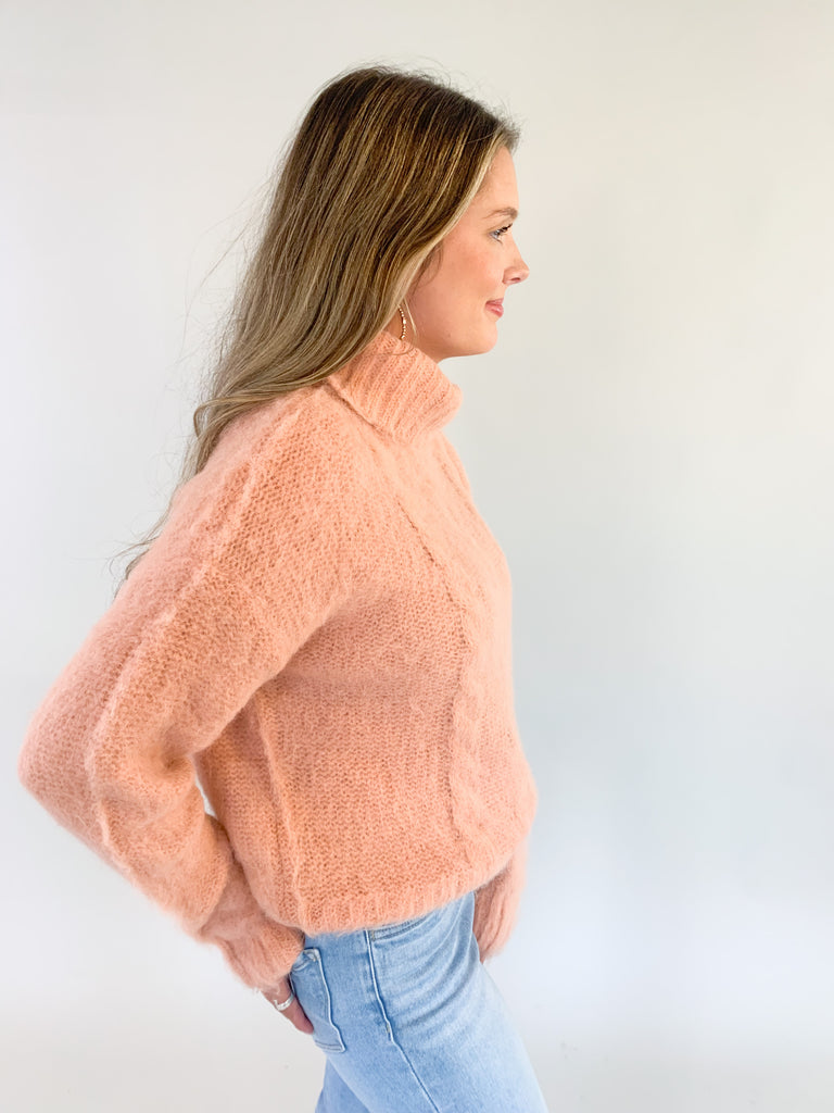 The Molly Bracken Eyelash Cable Knit Turtleneck Sweater is so pretty and luxe! The fabric is super soft with a unique eyelash cable knit fabric. The oversized chunky turtleneck look could not be more classic than this. You can dress it up or down for so many occasions. 