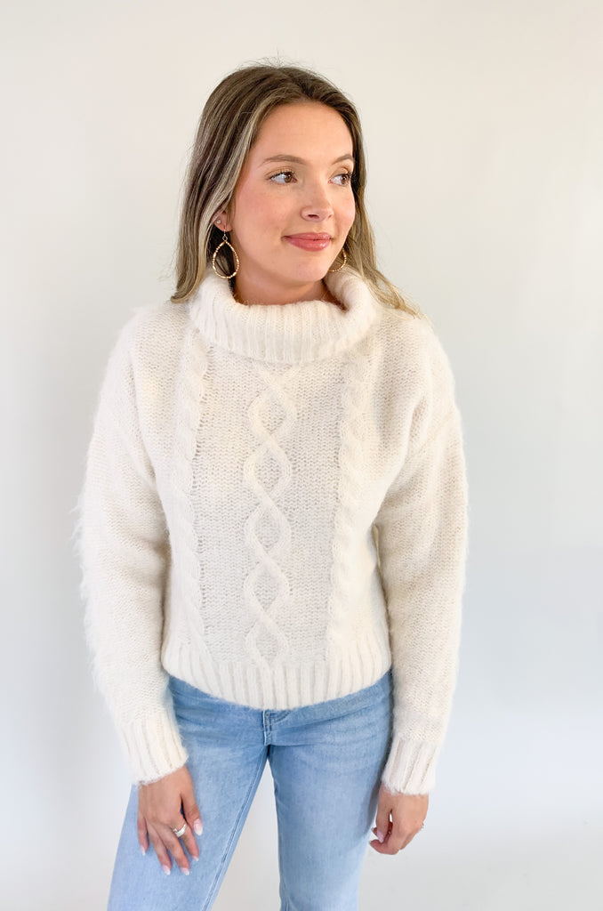 The Molly Bracken Eyelash Cable Knit Turtleneck Sweater is so pretty and luxe! The fabric is super soft with a unique eyelash cable knit fabric. The oversized chunky turtleneck look could not be more classic than this. You can dress it up or down for so many occasions. 