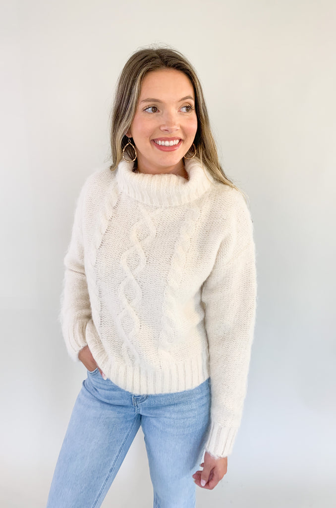 The Molly Bracken Eyelash Cable Knit Turtleneck Sweater is so pretty and luxe! The fabric is super soft with a unique eyelash cable knit fabric. The oversized chunky turtleneck look could not be more classic than this. You can dress it up or down for so many occasions. 