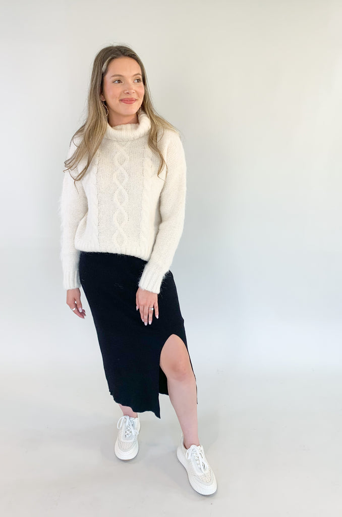 The Molly Bracken Eyelash Cable Knit Turtleneck Sweater is so pretty and luxe! The fabric is super soft with a unique eyelash cable knit fabric. The oversized chunky turtleneck look could not be more classic than this. You can dress it up or down for so many occasions. 