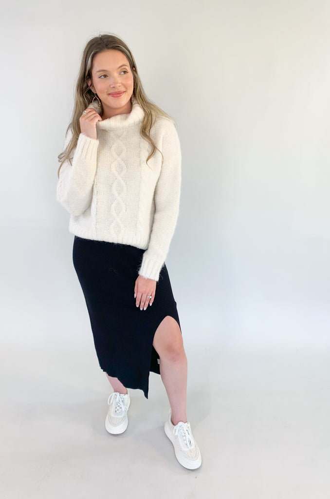 The Molly Bracken Eyelash Cable Knit Turtleneck Sweater is so pretty and luxe! The fabric is super soft with a unique eyelash cable knit fabric. The oversized chunky turtleneck look could not be more classic than this. You can dress it up or down for so many occasions. 