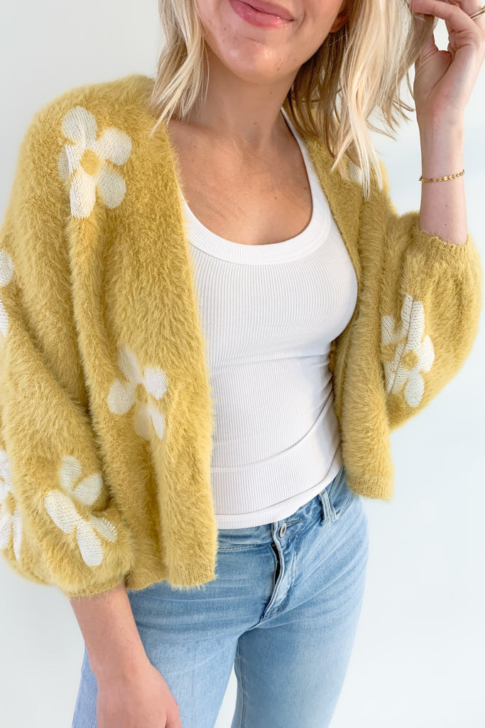 The Eyelash Daisy Cardigan is so cute and very groovy! If you are loving the 70s style trend, this layering piece is for you. It's ultra soft and cozy with fun balloon sleeves and a cropped silhouette. 