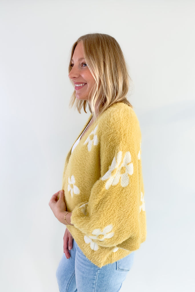 The Eyelash Daisy Cardigan is so cute and very groovy! If you are loving the 70s style trend, this layering piece is for you. It's ultra soft and cozy with fun balloon sleeves and a cropped silhouette. 