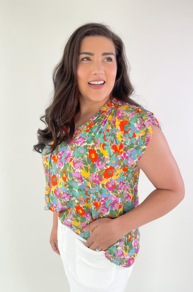 This Feel Good Floral Ruffle Sleeve Blouse is perfect for days when you want to feel your best! It's vibrant and designed for fun. Crafted with a lightweight fabric, it feels great in this summer heat. This blouse has beautiful ruffle cap sleeves, a v neck design, and a vibrant floral print that adds a pop of color to any look!