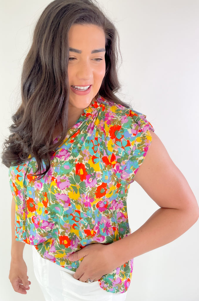 This Feel Good Floral Ruffle Sleeve Blouse is perfect for days when you want to feel your best! It's vibrant and designed for fun. Crafted with a lightweight fabric, it feels great in this summer heat. This blouse has beautiful ruffle cap sleeves, a v neck design, and a vibrant floral print that adds a pop of color to any look!