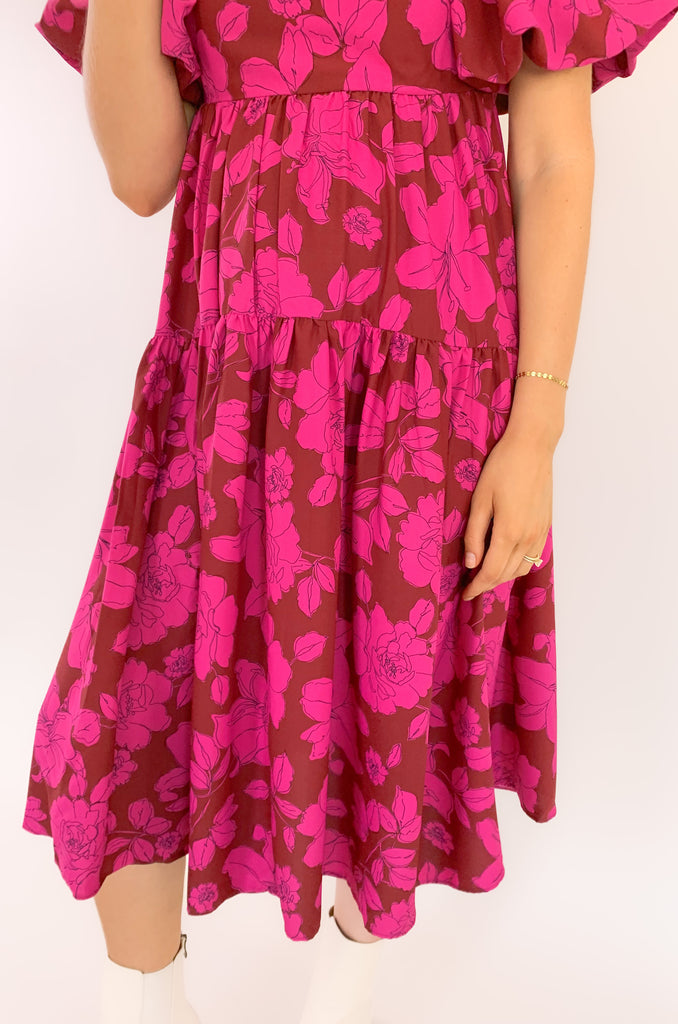 The Floral Print Square Neck Midi Dress is a stunner! It combines the two hottest colors of the season: pink and red. The gorgeous floral print is so fun too. It speaks to fall with a playful twist, especially with the babydoll square neckline and puff sleeves. 