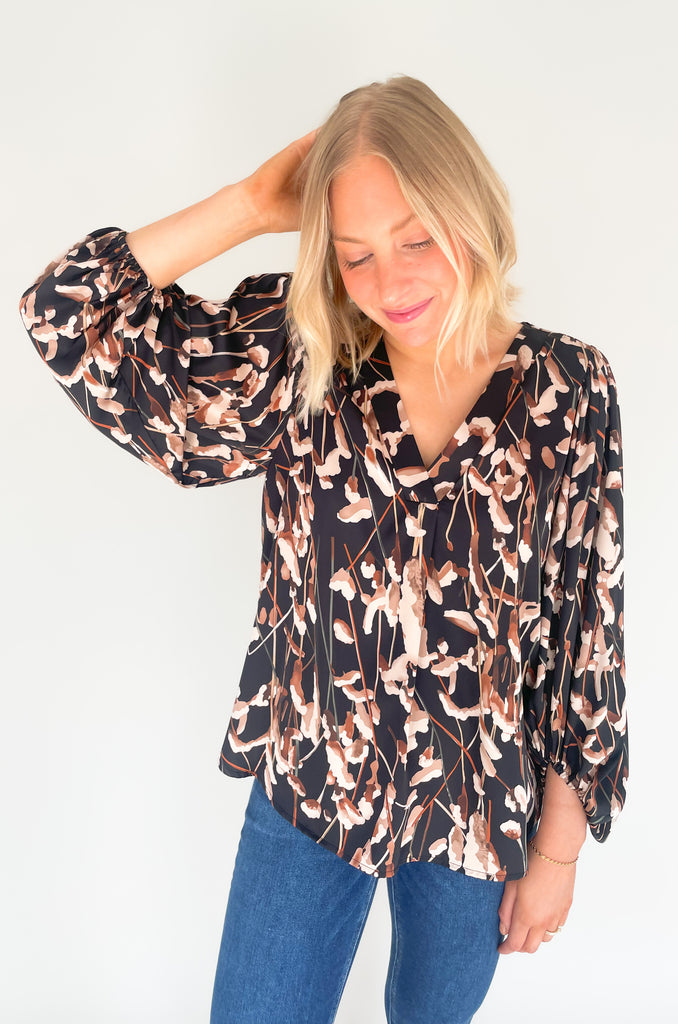 black v neck blouse with balloon sleeves and floral print