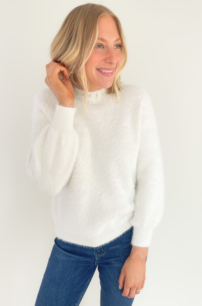 Our new Molly Bracken Pullover features a row of elegant pearls and comes in two classic colors! If you feel the fabric, you will instantly fall in love with the softness. This sweater has an ultra cozy eyelash fabrication, making if so cozy for the holiday season. You could totally dress it up to wear to holiday parties, works, and all the special days in between. 