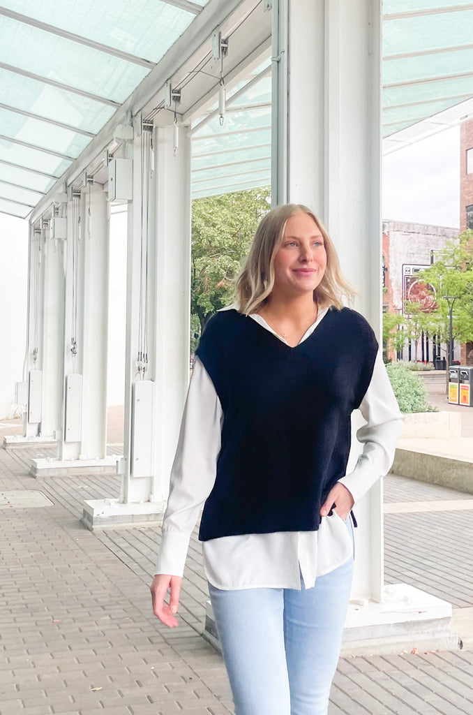 Stay stylish when the weather cools down with the Elan Geist Black Sweater Vest & Layered Blouse! This unique one-piece is made of knit fabric to keep you warm and comfortable, while featuring a flattering satin blouse underneath.