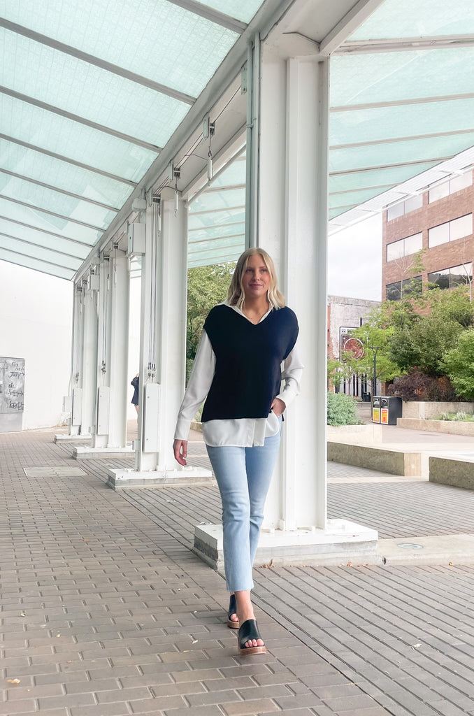 Stay stylish when the weather cools down with the Elan Geist Black Sweater Vest & Layered Blouse! This unique one-piece is made of knit fabric to keep you warm and comfortable, while featuring a flattering satin blouse underneath.