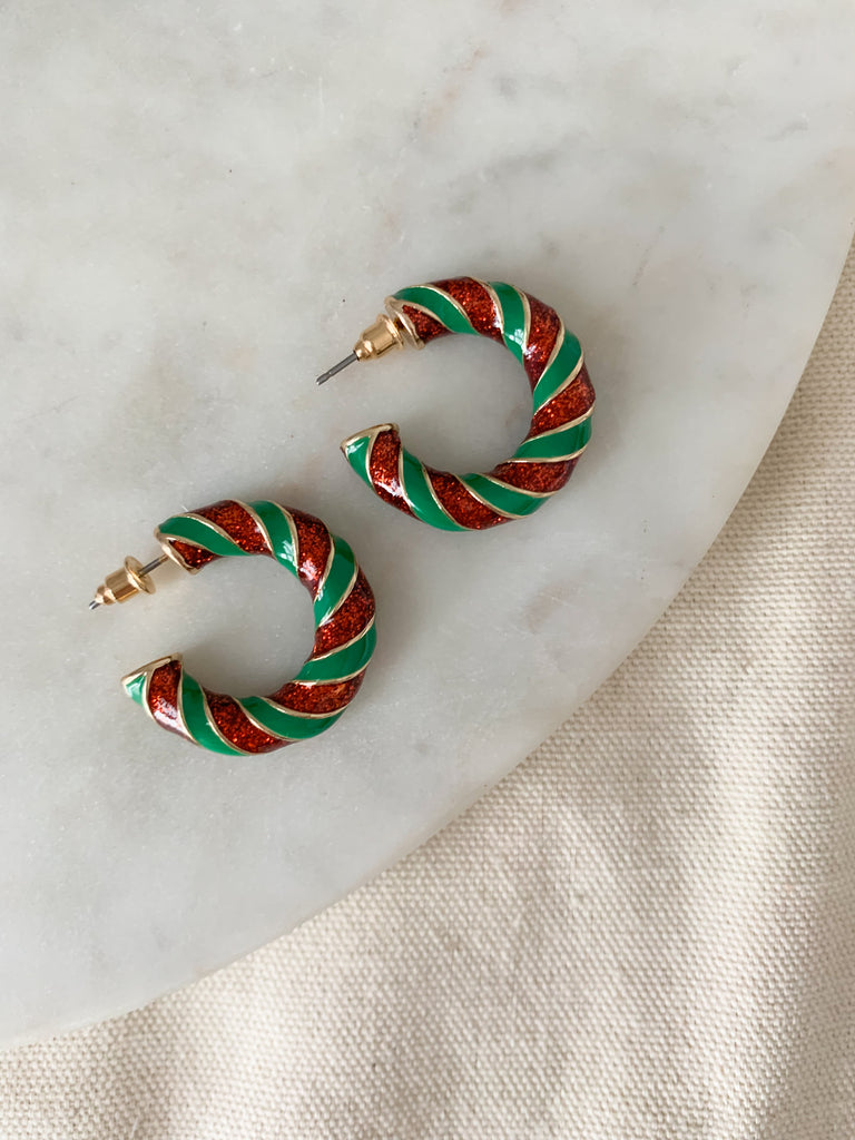 The Glitter Candy Cane Green & Red Gold Hoops are cute and fun for the holiday season! They are subtle way to play with holiday colors, but can be worn with anything.  