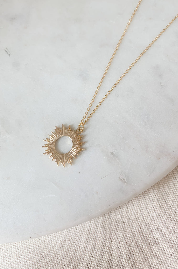 Sparkle as bright as the sun with this Gold Dipped Small Open Sun Pendant Necklace!  The shape and design speaks to the warmer weather ahead. It's lightweight, simple, and will surely elevated any look. 
