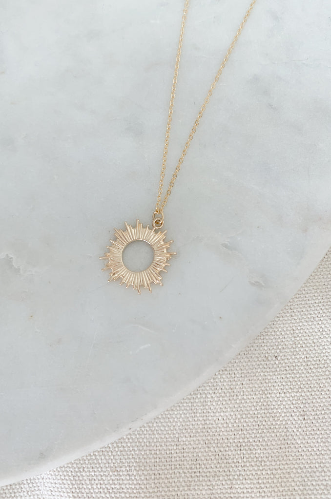 Sparkle as bright as the sun with this Gold Dipped Small Open Sun Pendant Necklace!  The shape and design speaks to the warmer weather ahead. It's lightweight, simple, and will surely elevated any look. 