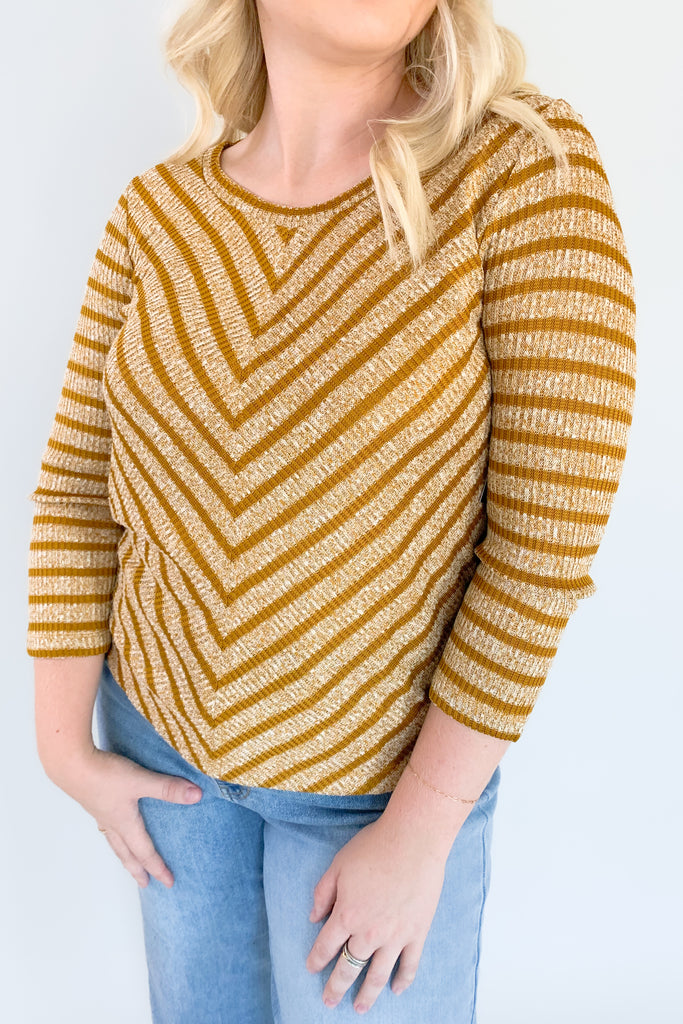 This beautiful Liverpool Gold Stripe 3/4 Sleeve Scoop Neck Top features a unique mitering detail on the front with a scoop neckline. The color and print is unique too. If you are looking of an elevated everyday favorite, this one is a great option. It pairs back to denim effortlessly!