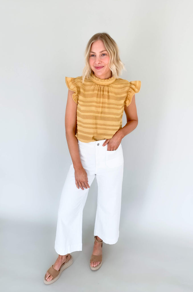 Look your best in our Good Days Ruffle Sleeveless Textured Top! With round neckline and striped texture, your days will be sunshine and rainbows, even when the atmosphere's a little grey. The fabric is elevated and comfortable, perfect for life's events. Choose from mustard, ivory, and navy to find your perfect color – no matter the forecast!