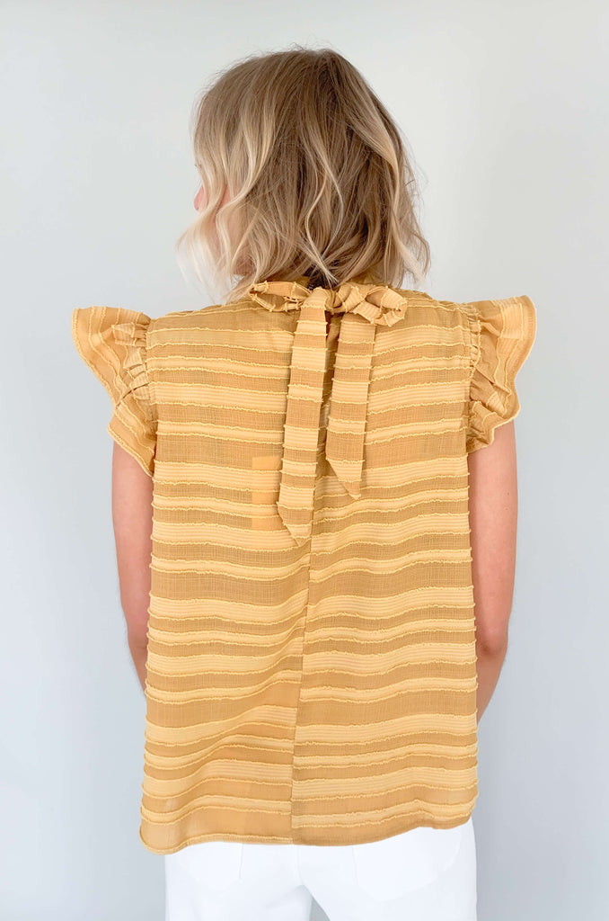 Look your best in our Good Days Ruffle Sleeveless Textured Top! With round neckline and striped texture, your days will be sunshine and rainbows, even when the atmosphere's a little grey. The fabric is elevated and comfortable, perfect for life's events. Choose from mustard, ivory, and navy to find your perfect color – no matter the forecast!
