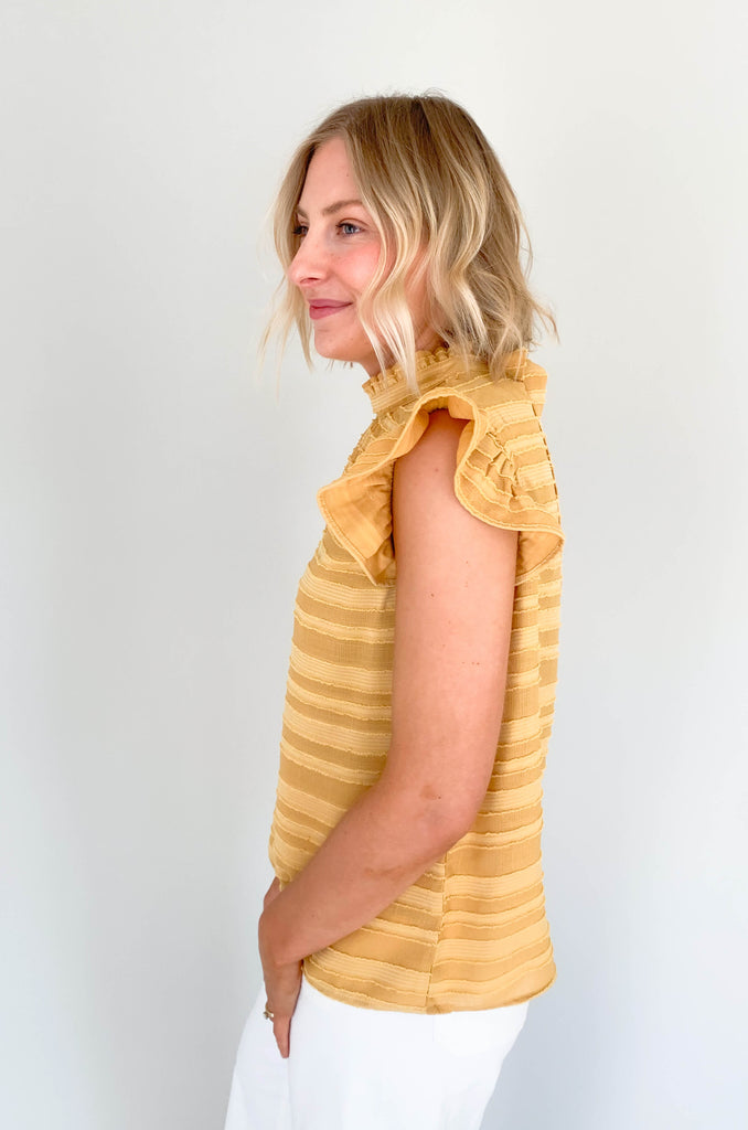 Look your best in our Good Days Ruffle Sleeveless Textured Top! With round neckline and striped texture, your days will be sunshine and rainbows, even when the atmosphere's a little grey. The fabric is elevated and comfortable, perfect for life's events. Choose from mustard, ivory, and navy to find your perfect color – no matter the forecast!