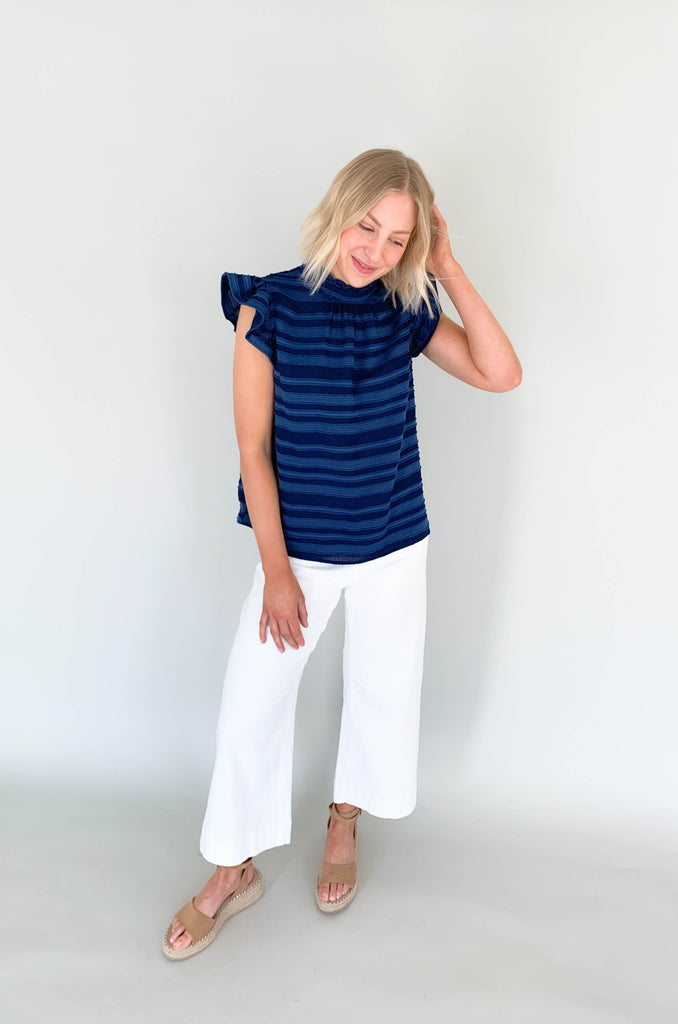 Look your best in our Good Days Ruffle Sleeveless Textured Top! With round neckline and striped texture, your days will be sunshine and rainbows, even when the atmosphere's a little grey. The fabric is elevated and comfortable, perfect for life's events. Choose from mustard, ivory, and navy to find your perfect color – no matter the forecast!