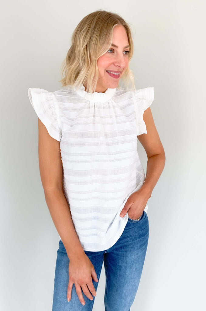 Look your best in our Good Days Ruffle Sleeveless Textured Top! With round neckline and striped texture, your days will be sunshine and rainbows, even when the atmosphere's a little grey. The fabric is elevated and comfortable, perfect for life's events. Choose from mustard, ivory, and navy to find your perfect color – no matter the forecast!