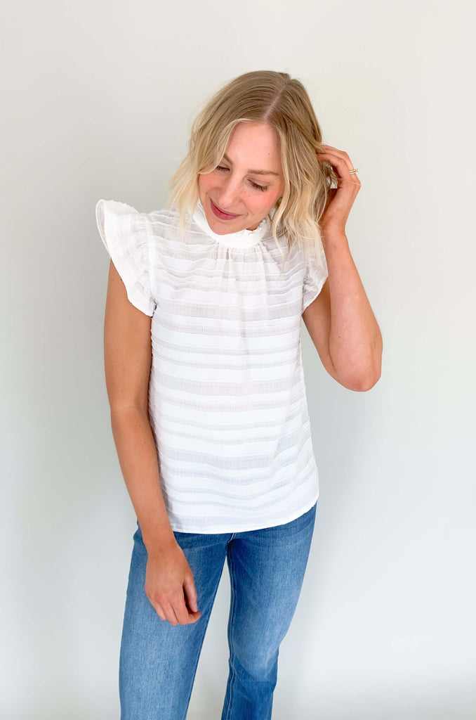 Look your best in our Good Days Ruffle Sleeveless Textured Top! With round neckline and striped texture, your days will be sunshine and rainbows, even when the atmosphere's a little grey. The fabric is elevated and comfortable, perfect for life's events. Choose from mustard, ivory, and navy to find your perfect color – no matter the forecast!