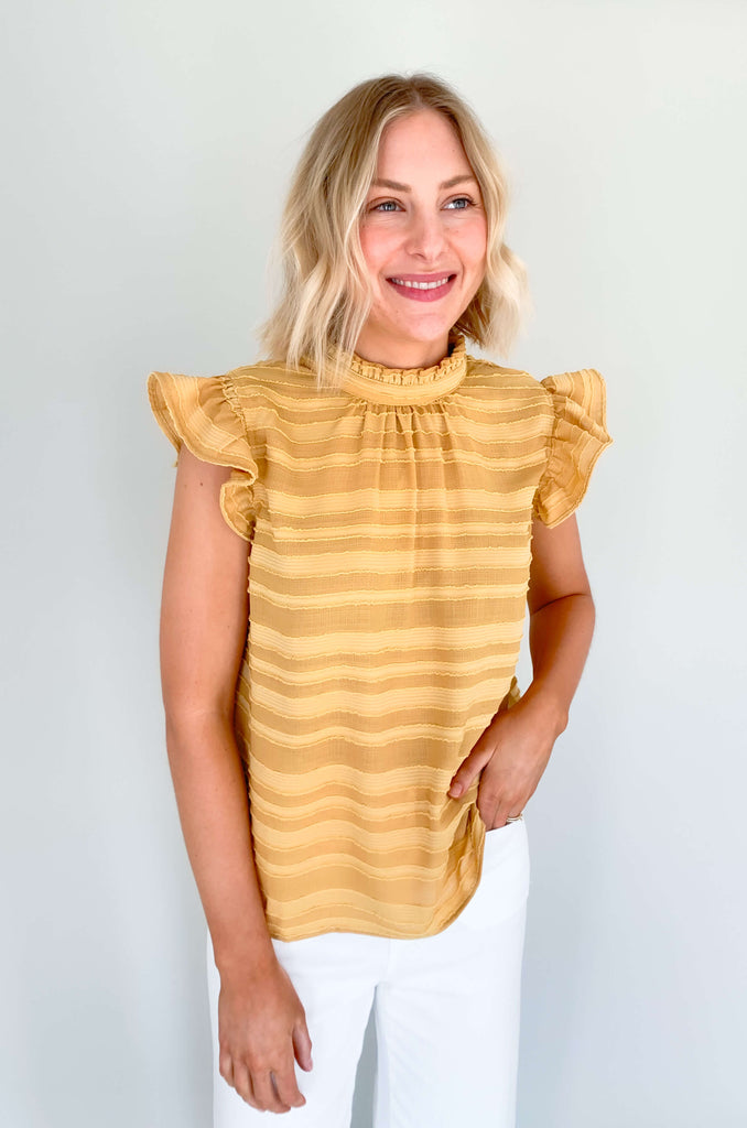 Look your best in our Good Days Ruffle Sleeveless Textured Top! With round neckline and striped texture, your days will be sunshine and rainbows, even when the atmosphere's a little grey. The fabric is elevated and comfortable, perfect for life's events. Choose from mustard, ivory, and navy to find your perfect color – no matter the forecast!