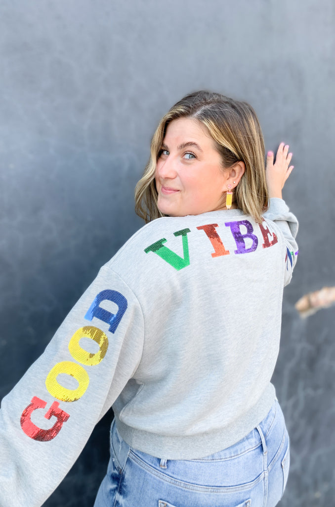 Cropped sequin pullover that says " GOOD VIBES ONLY". Cropped with a stretchy waistband and same material on the wrist. Available in Fuchsia or heather Gray in size small-large