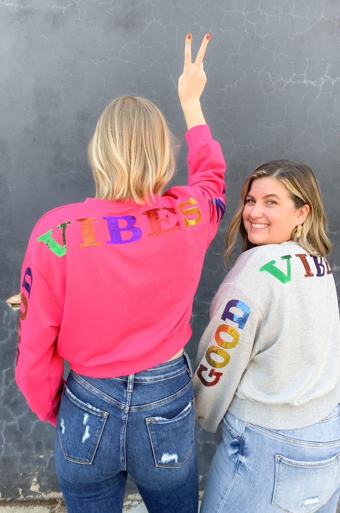 Cropped sequin pullover that says " GOOD VIBES ONLY". Cropped with a stretchy waistband and same material on the wrist. Available in Fuchsia or heather Gray in size small-large