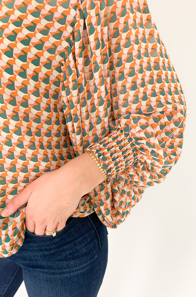 This Groovy Orange Printed Cuffed Button Down has a lightweight sheer material and features a stylish collar and cinched wrists for a sleek work look! The stylish print brings an extra splash of fashion to any outfit, making it the perfect transitional piece for any wardrobe!
