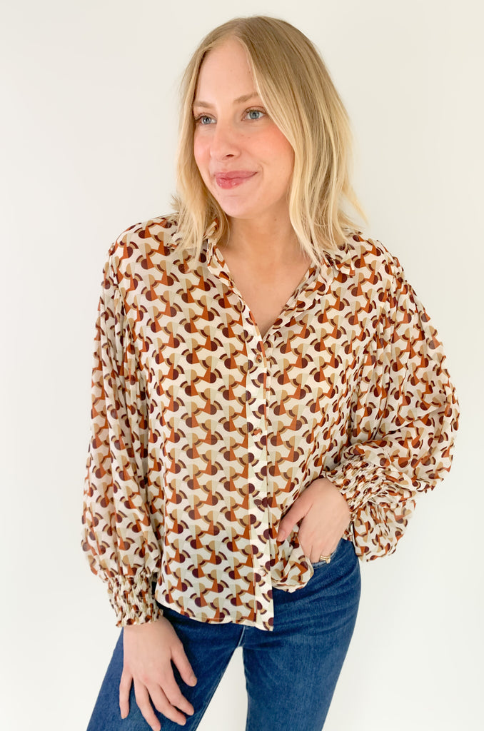 This Terracotta Geometric Printed Cuffed Button Down is the perfect way to add a classic yet stylish look to your wardrobe. Lightweight sheer material, a traditional collar, and cuffed wrists make it versatile for any temperature or occasion! Make an impression with this stylish piece! 