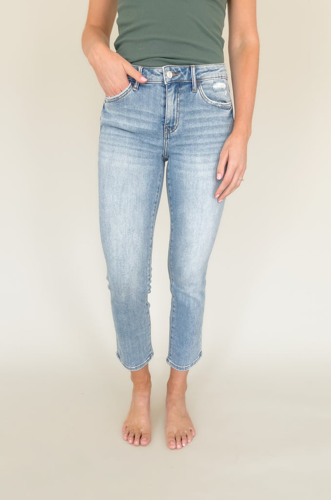 Light wash mid rise straight leg jeans with slight distressing around the pockets. 