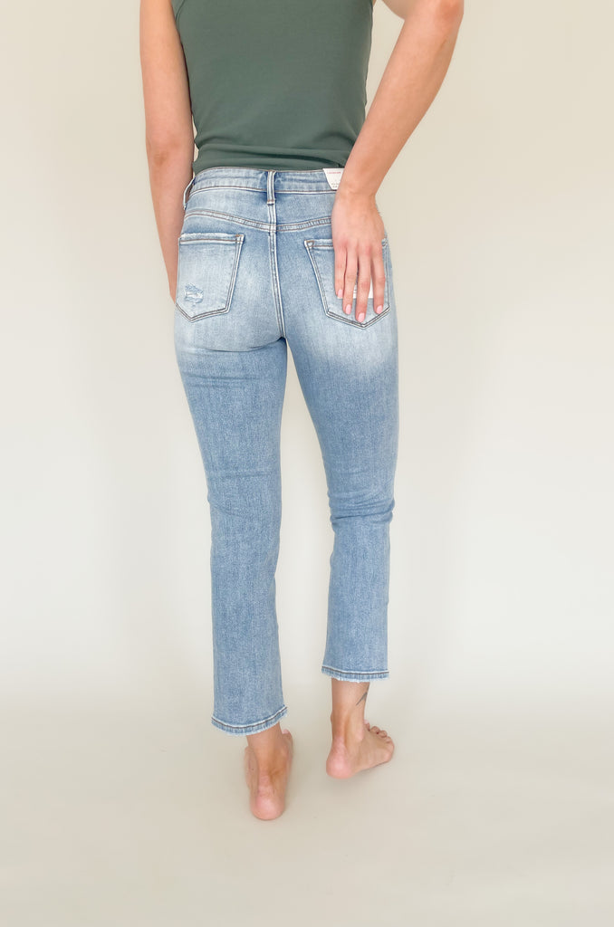 Light wash mid rise straight leg jeans with slight distressing around the pockets. 