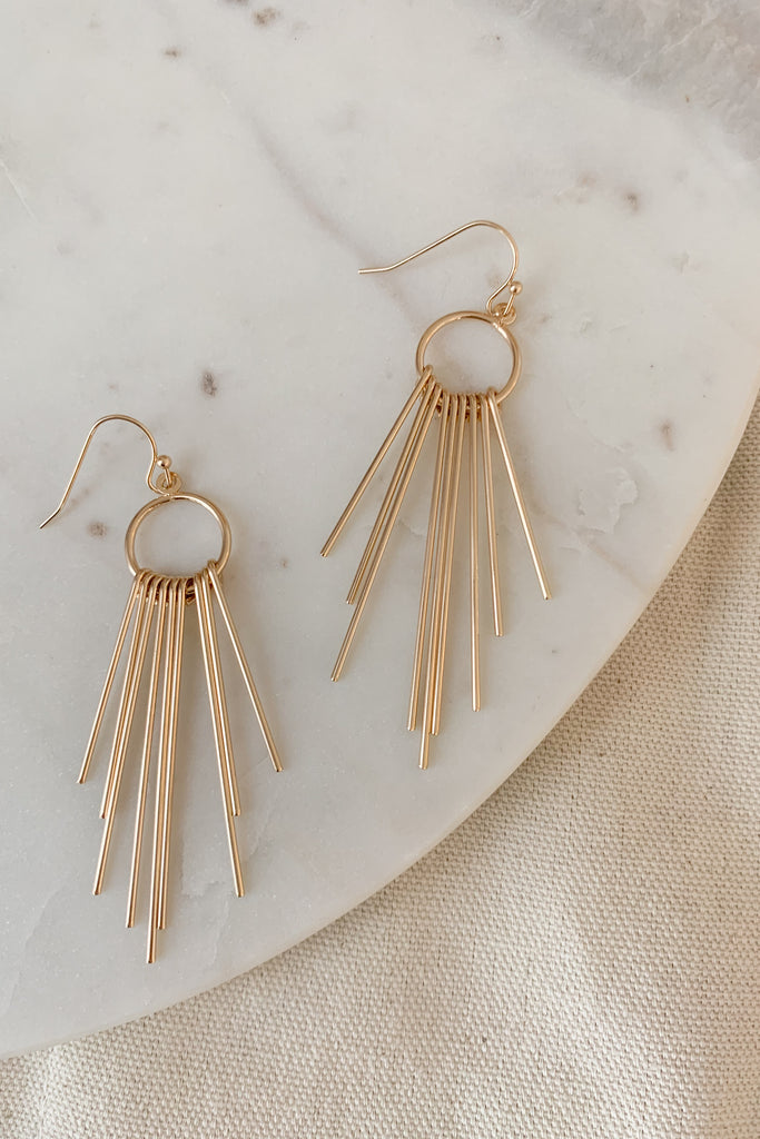 The Hoop and Long Skinny Gold Dangle Earrings are so pretty! The long starburst like dangles create an elevated statement while being lightweight and comfortable. Wear these to complete any look!