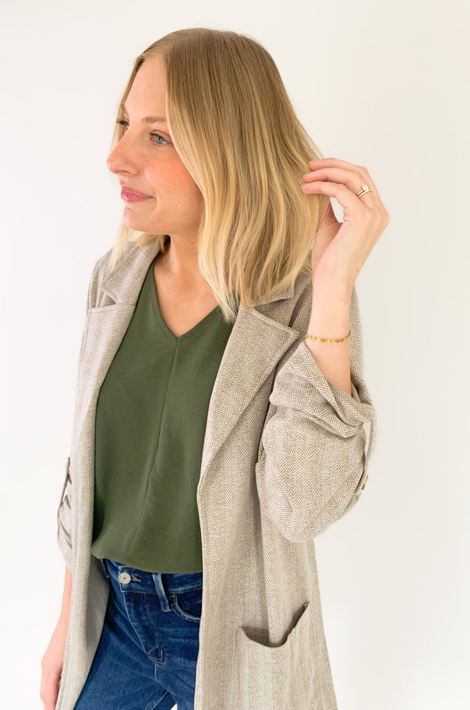 This Hutch Herringbone Roll Tab Coat is perfect for any occasion! It features a natural herringbone fabric with button detailing on the cuffs and side pockets for extra convenience. 