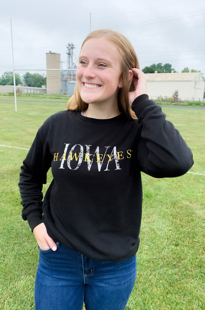 The IOWA Brooks Bock Fleece Crewneck is perfect for hawkeyes fans! Its black fleece and yellow embroidered "Hawkeyes" and printed "IOWA" create a stylish statement. Aside from being perfect for game day, it's also extremely soft and cozy. Show your school spirit with this high-quality crewneck for this fall, or gift one to your favorite Iowa Alum.