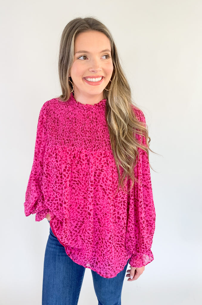 Magenta pink with leopard print blouse with ruched details, flowy body, and balloon sleeves