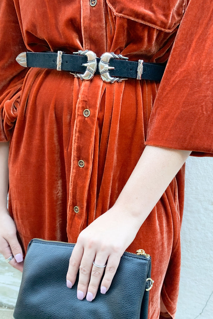 The Western Inspired Double Buckle Belt is super trendy with silver hardware. It adds a little edgy western flare to any look!