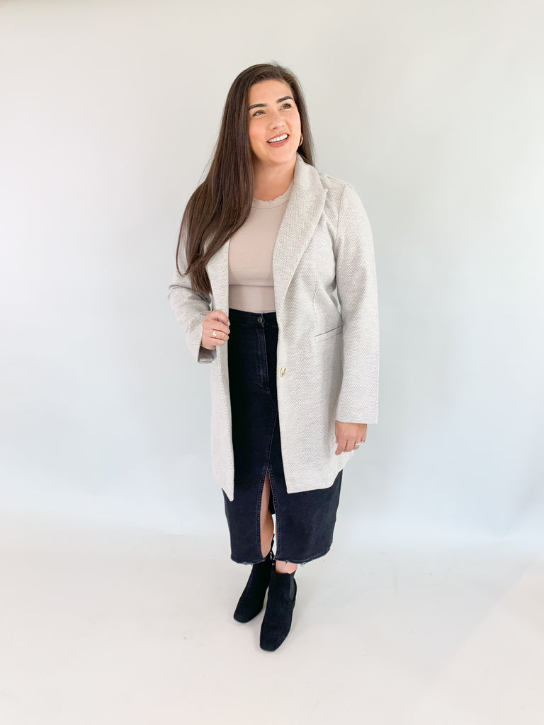  An embodiment of warmth, style, and contemporary flair. Wrap yourself in the cozy embrace of this meticulously crafted sweater coat, where comfort meets fashion seamlessly.