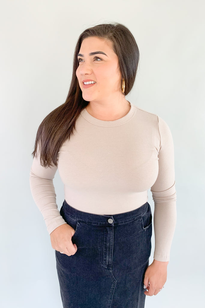 This classic Jen Round Neck Long Sleeve Knit Top is made of a soft fabric, ensuring comfort and style. It's great on its own, but the fitted silhouette makes it a great option for layering. The fabric is very soft and stretchy too. Perfect for any occasion, this piece is sure to become a staple in any wardrobe.
