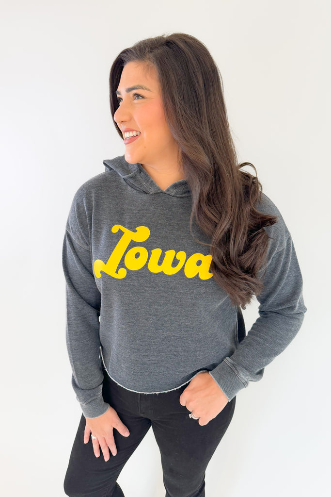 Stay cozy and cool  with this Iowa Groovy Raw Edge Hoodie! The soft fleece interior and 70s-inspired Iowa text combine a fun, vintage look. Semi-cropped with long sleeves, this hoody is perfect for any Hawkeye.